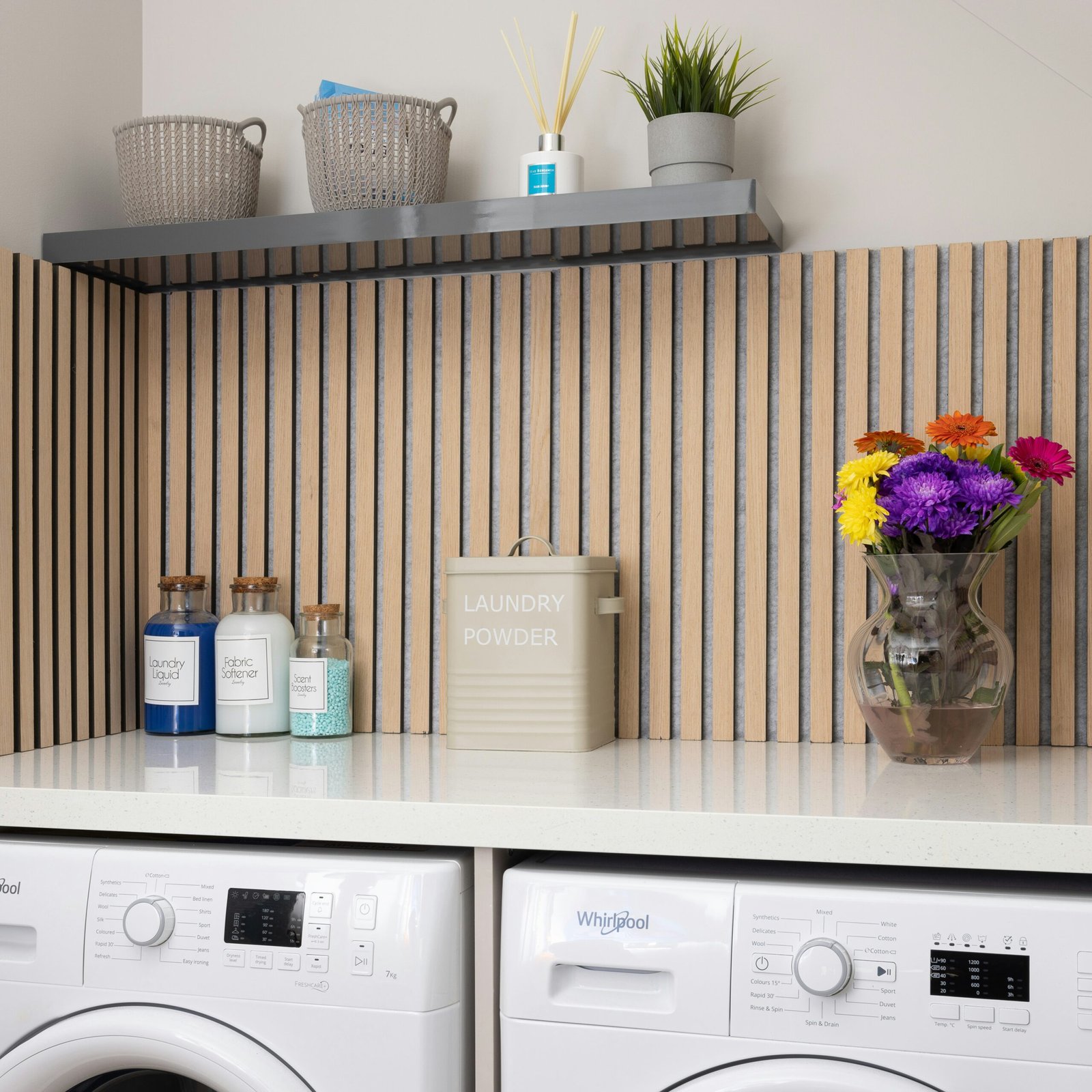 a white washer sitting next to a dryer on top of a counter